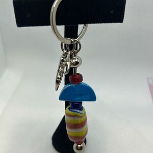 Purse dangle/key ring has colorful glass beads and homemade ceramic bead